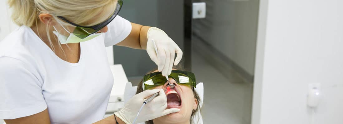 banner with doctor with patient with mouth mirror in mouth