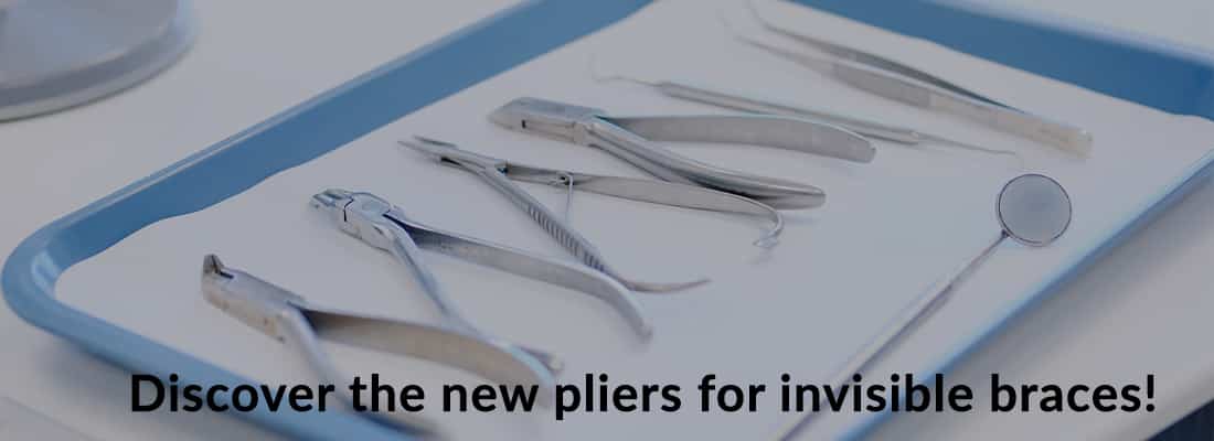 banner with pliers, tweezers, mouth mirror in tray